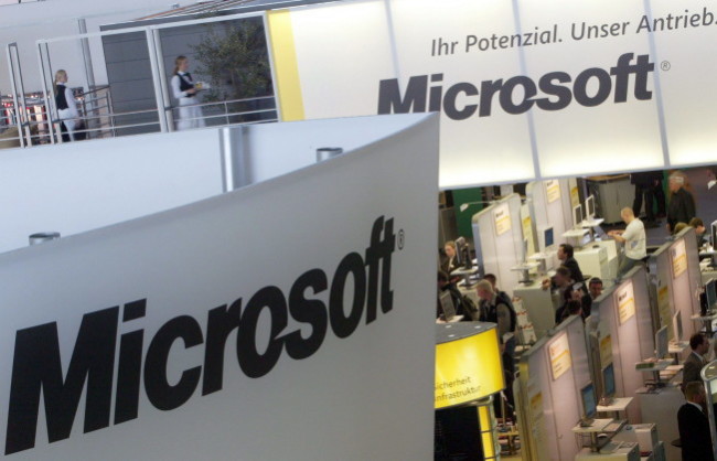 Visitors look around at the Microsoft stand at the world's largest computer trade fair CeBit